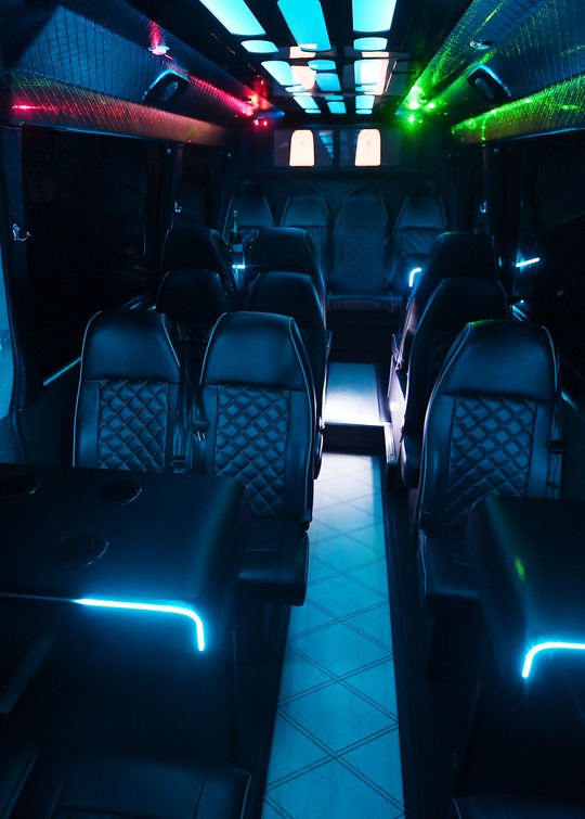 VIP Buses 2010 Mercedes Sprinter 16 Seater Party Bus aisle looking forward with tables lit cyan