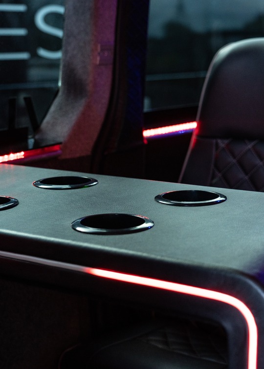 VIP Buses 2010 Mercedes Sprinter 16 Seater Party Bus drinks table with four holders and a red lit edge
