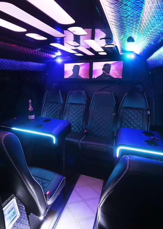VIP Buses 2010 Mercedes Sprinter 16 Seater Party Bus rear bench screens and champagne on the lit table