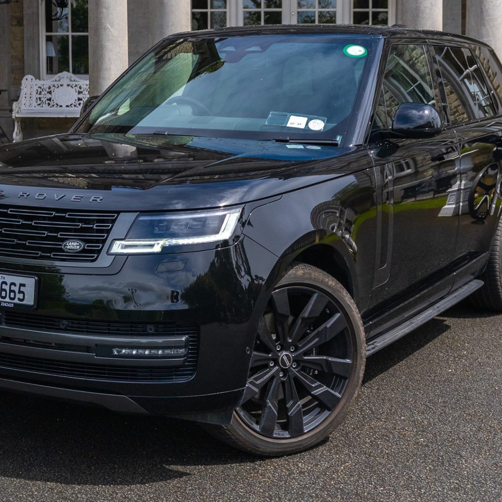 VIP Buses Black Range Rover Vogue SWB front three quarter outside the portico with cannons