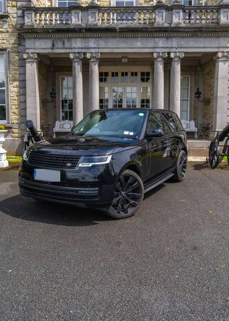 VIP Buses Black Range Rover Vogue SWB front three quarter outside the portico with cannons