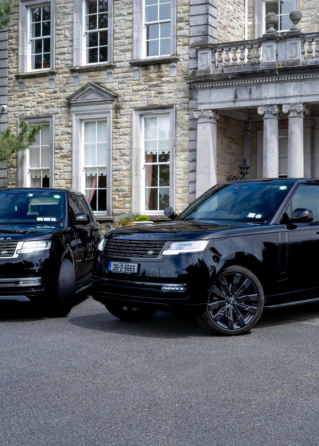 VIP Buses Black Range Rover Vogue SWB pair side by side outside a country house with cannons