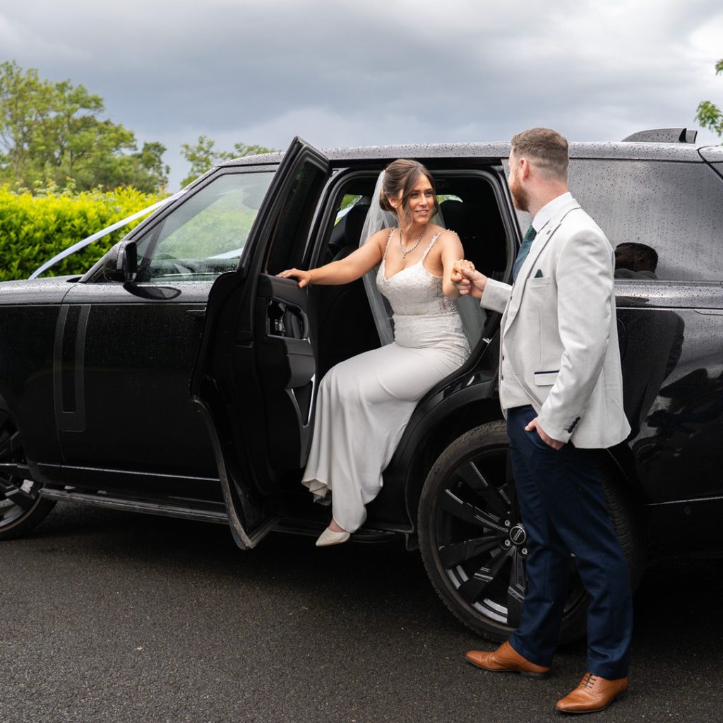 VIP Buses Black Range Rover Vogue SWB with the bride stepping out as the groom holds her hand