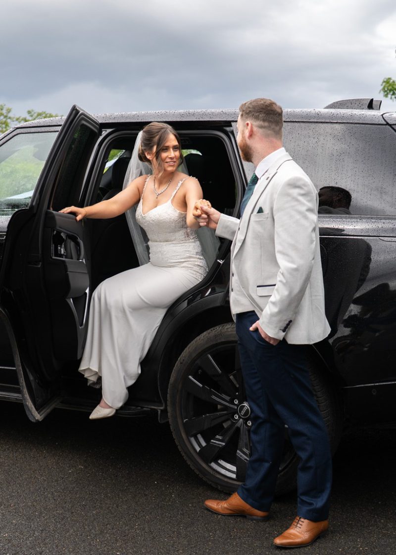 VIP Buses Black Range Rover Vogue SWB with the bride stepping out as the groom holds her hand
