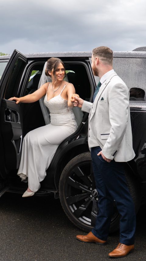 VIP Buses Black Range Rover Vogue SWB with the bride stepping out as the groom holds her hand
