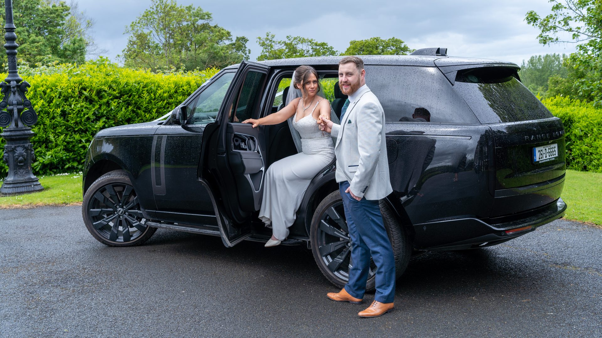 VIP Buses Black Range Rover Vogue SWB with the bride stepping out as the groom leads her hand