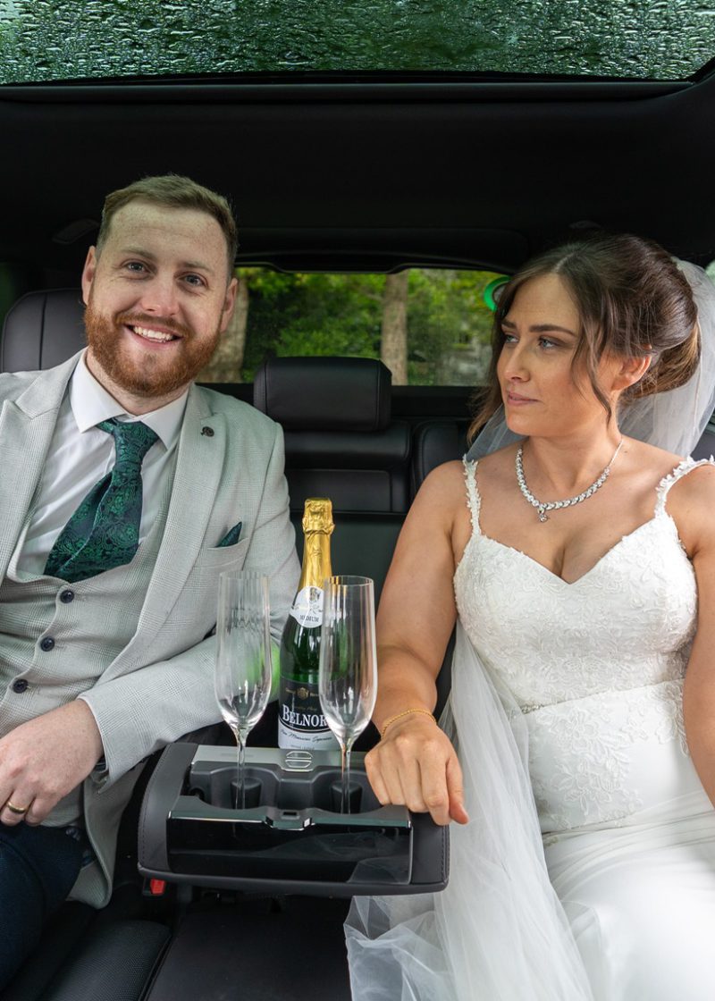 VIP Buses Black Range Rover Vogue SWB with the couple in the rear seats and champagne poured