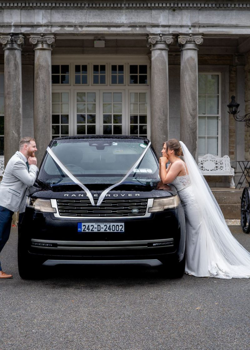 VIP Buses Black Range Rover Vogue SWB with the couple leaning on the bonnet facing each other