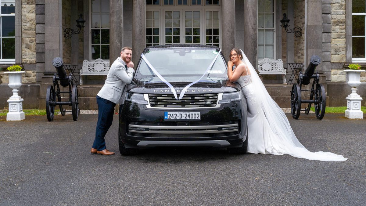 VIP Buses Black Range Rover Vogue SWB with the couple on the bonnet between two cannons