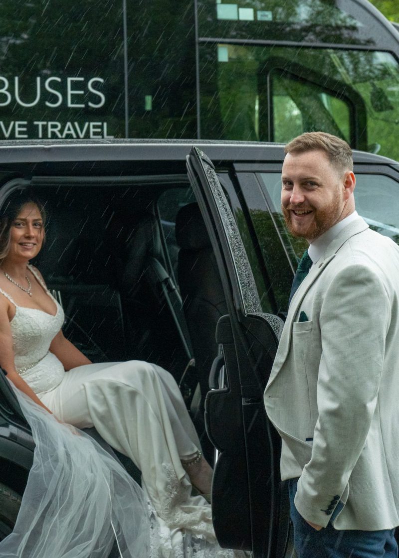 VIP Buses Black Range Rover Vogue SWB with the groom holding the door for the bride
