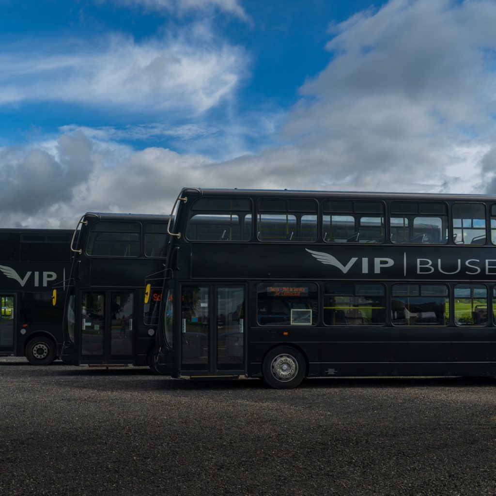 VIP Buses Double Decker Bus three parked in a row seen from the side at the depot