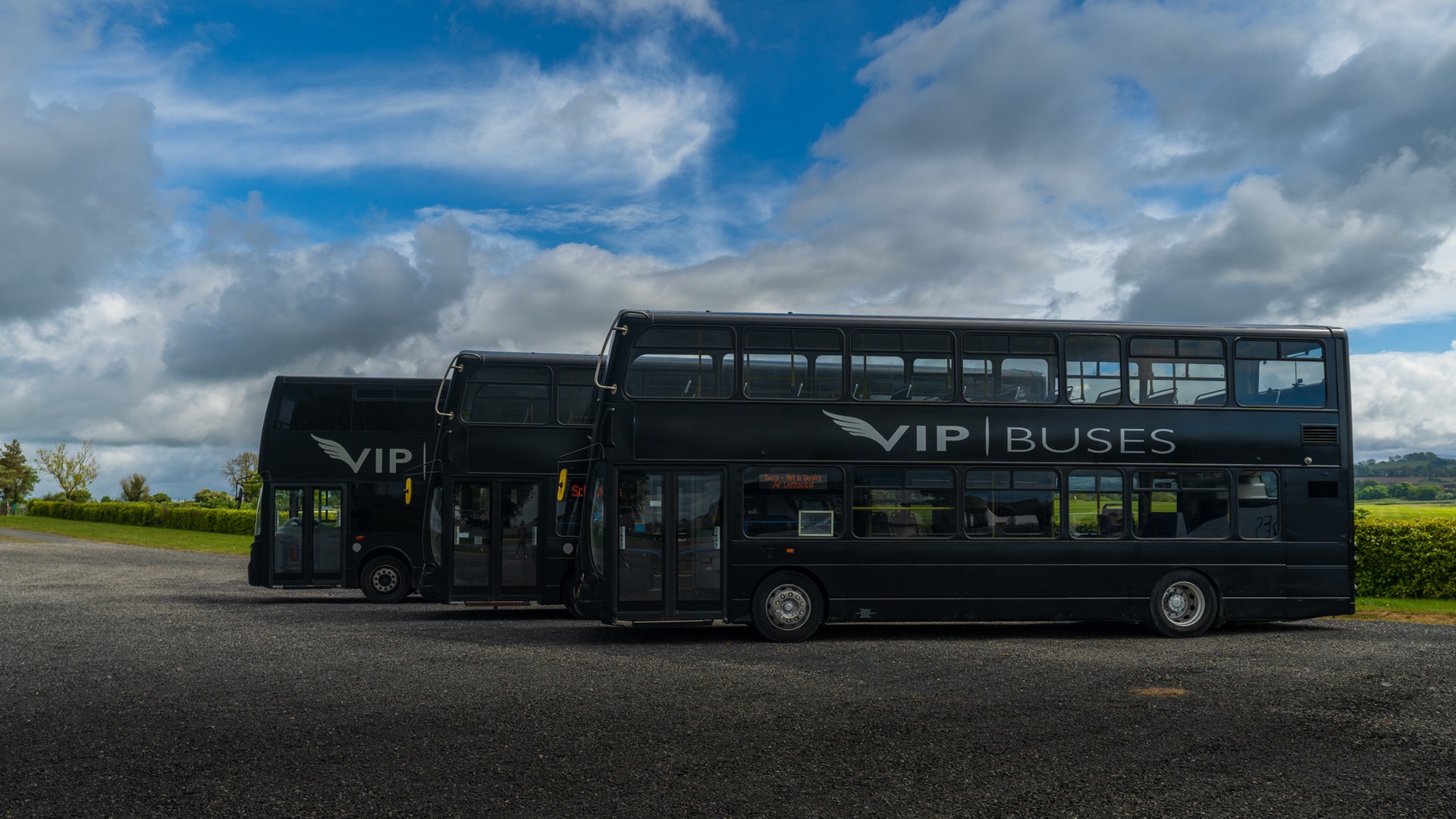 VIP Buses Double Decker Bus three parked in a row seen from the side at the depot