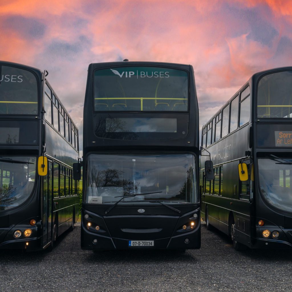 VIP Buses Double Decker Bus three parked side by side at the depot under a red sunset