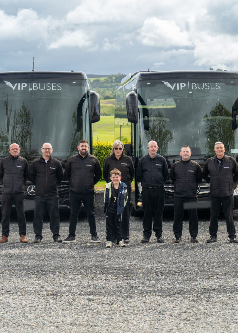 VIP Buses Fleet Lineup seven uniformed staff and a child in front of four coaches