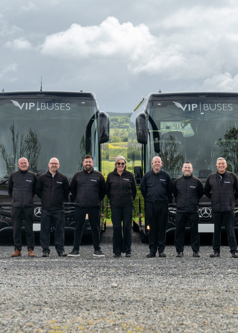 VIP Buses Fleet Lineup seven uniformed staff lined up in front of the fleet