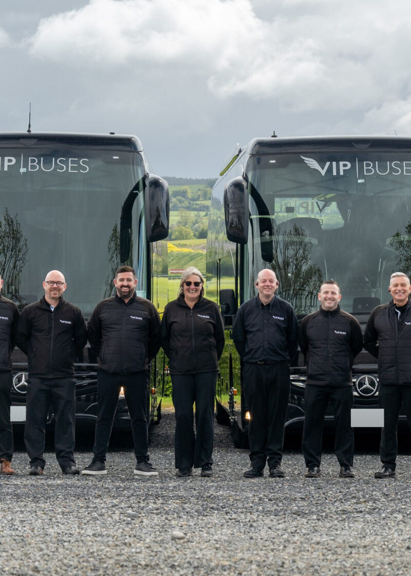 VIP Buses Fleet Lineup seven uniformed staff lined up in front of the fleet