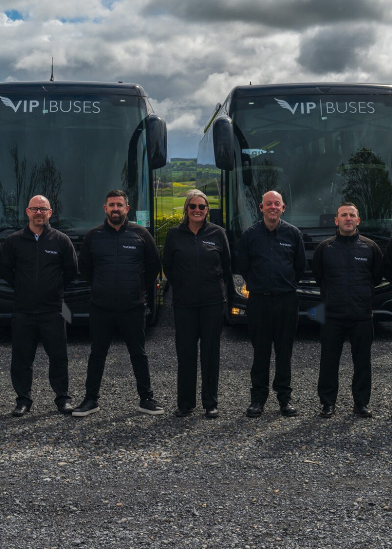 VIP Buses Fleet Lineup seven uniformed staff lined up in front of the fleet
