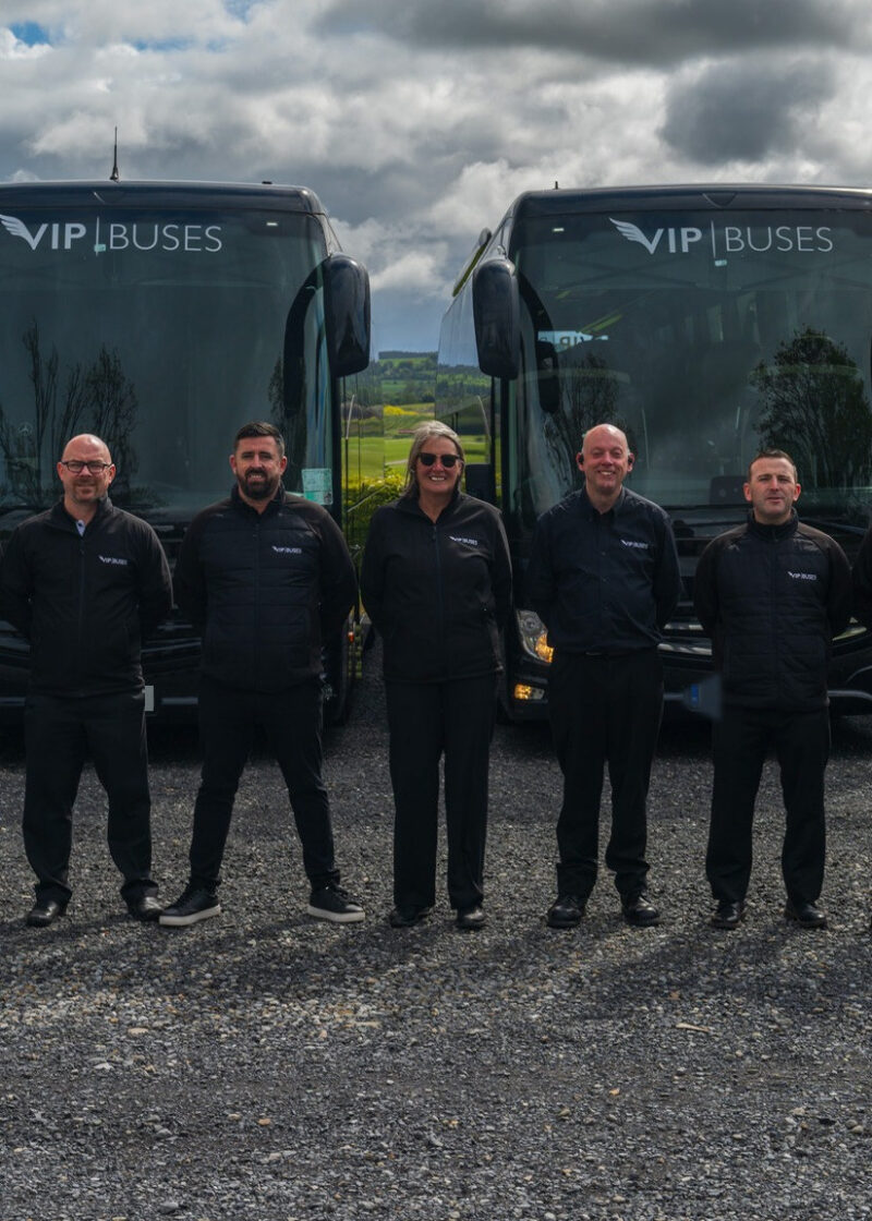 VIP Buses Fleet Lineup seven uniformed staff lined up in front of the fleet