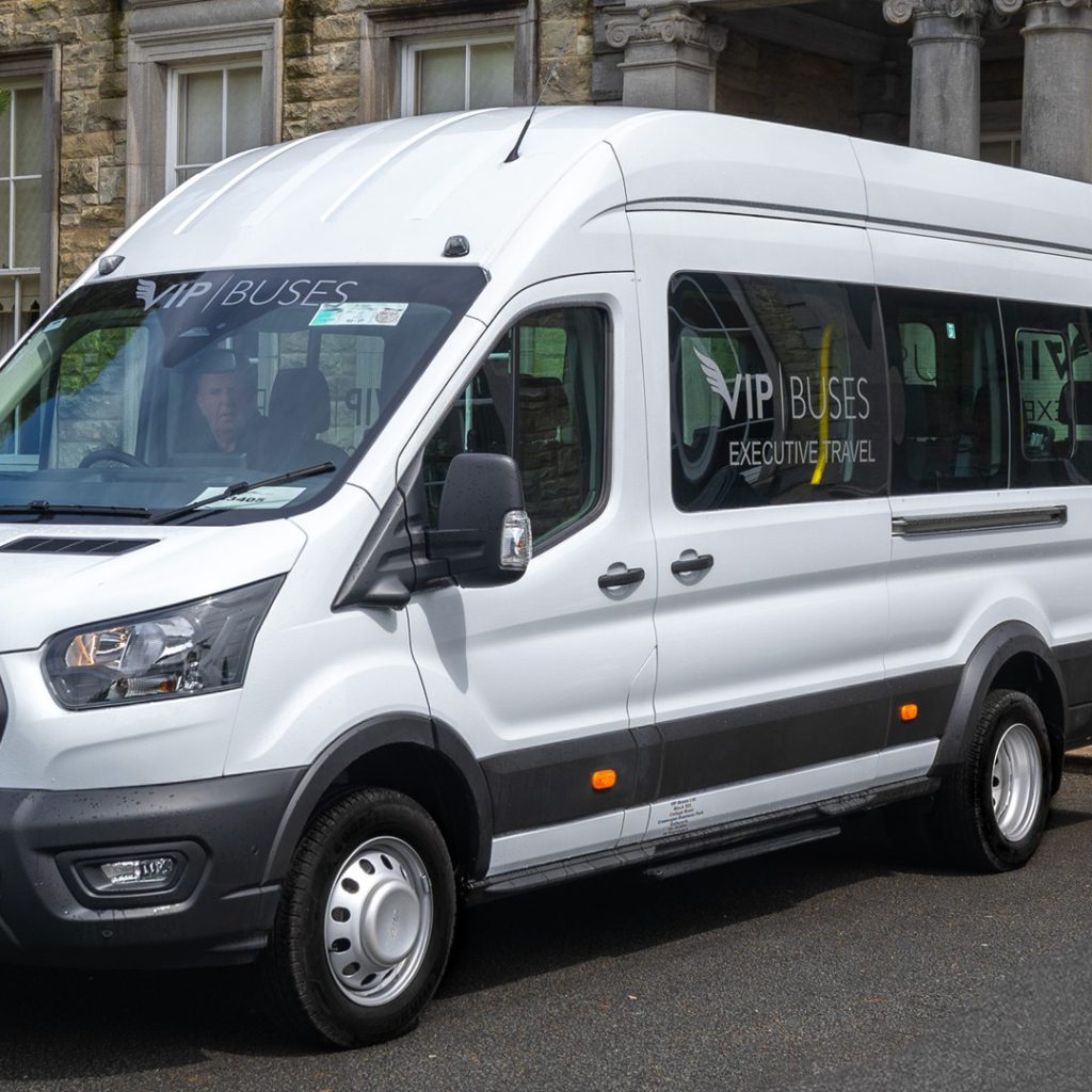 VIP Buses Ford Transit 17 Seater Minibus front three quarter below the house facade