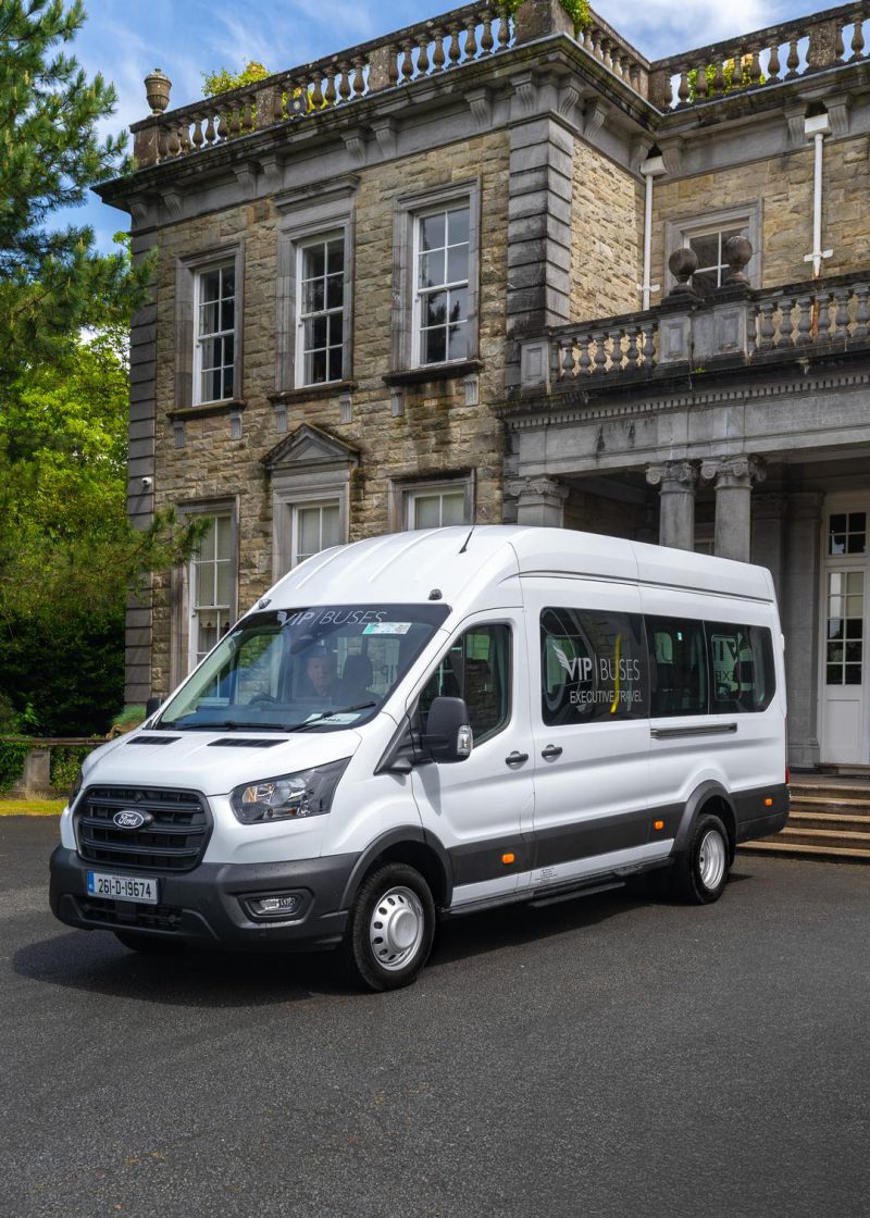 VIP Buses Ford Transit 17 Seater Minibus front three quarter below the house facade