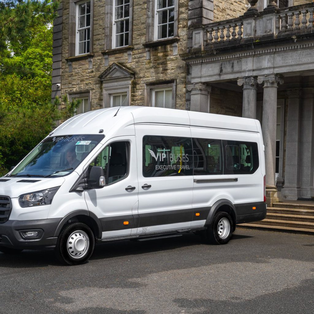 VIP Buses Ford Transit 17 Seater Minibus front three quarter beside a cannon