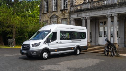 VIP Buses Ford Transit 17 Seater Minibus front three quarter beside a cannon