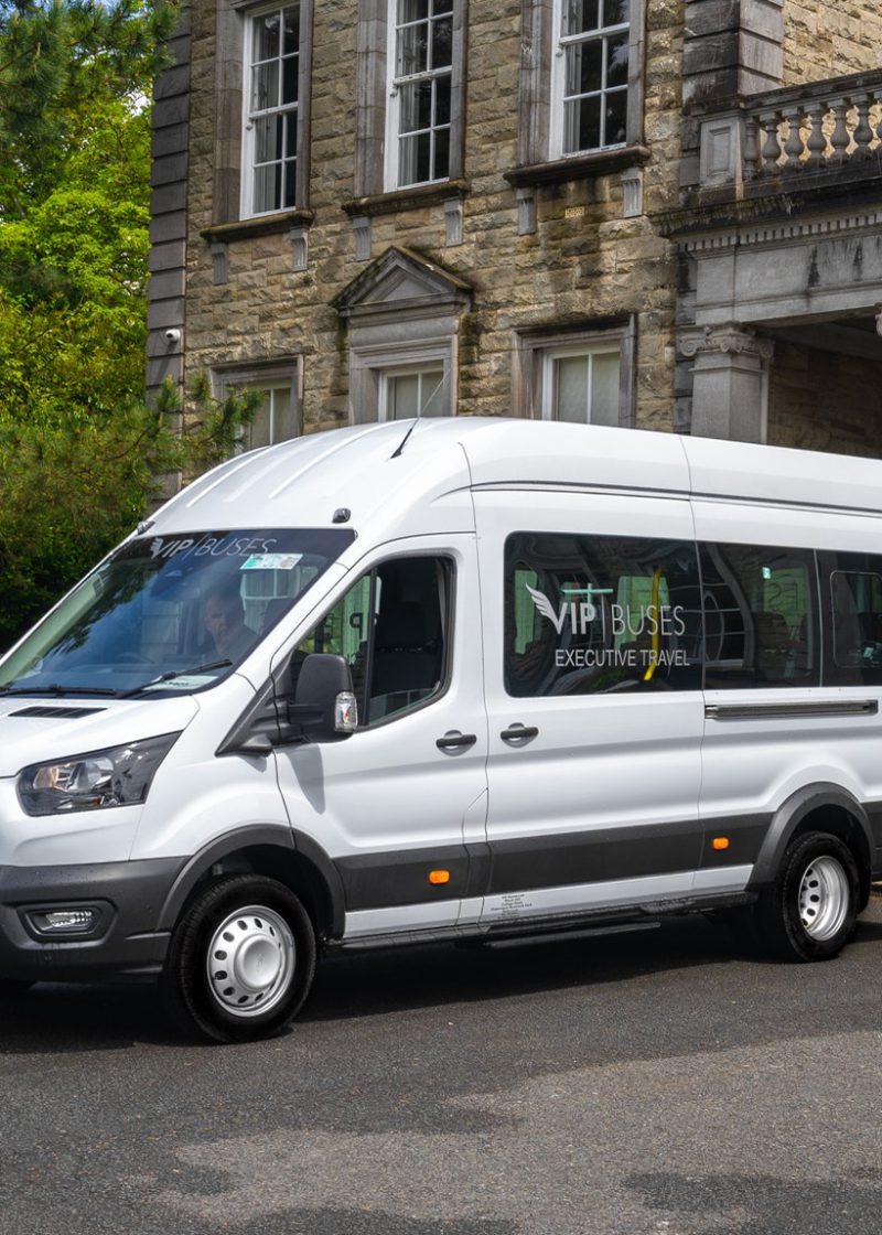 VIP Buses Ford Transit 17 Seater Minibus front three quarter beside a cannon