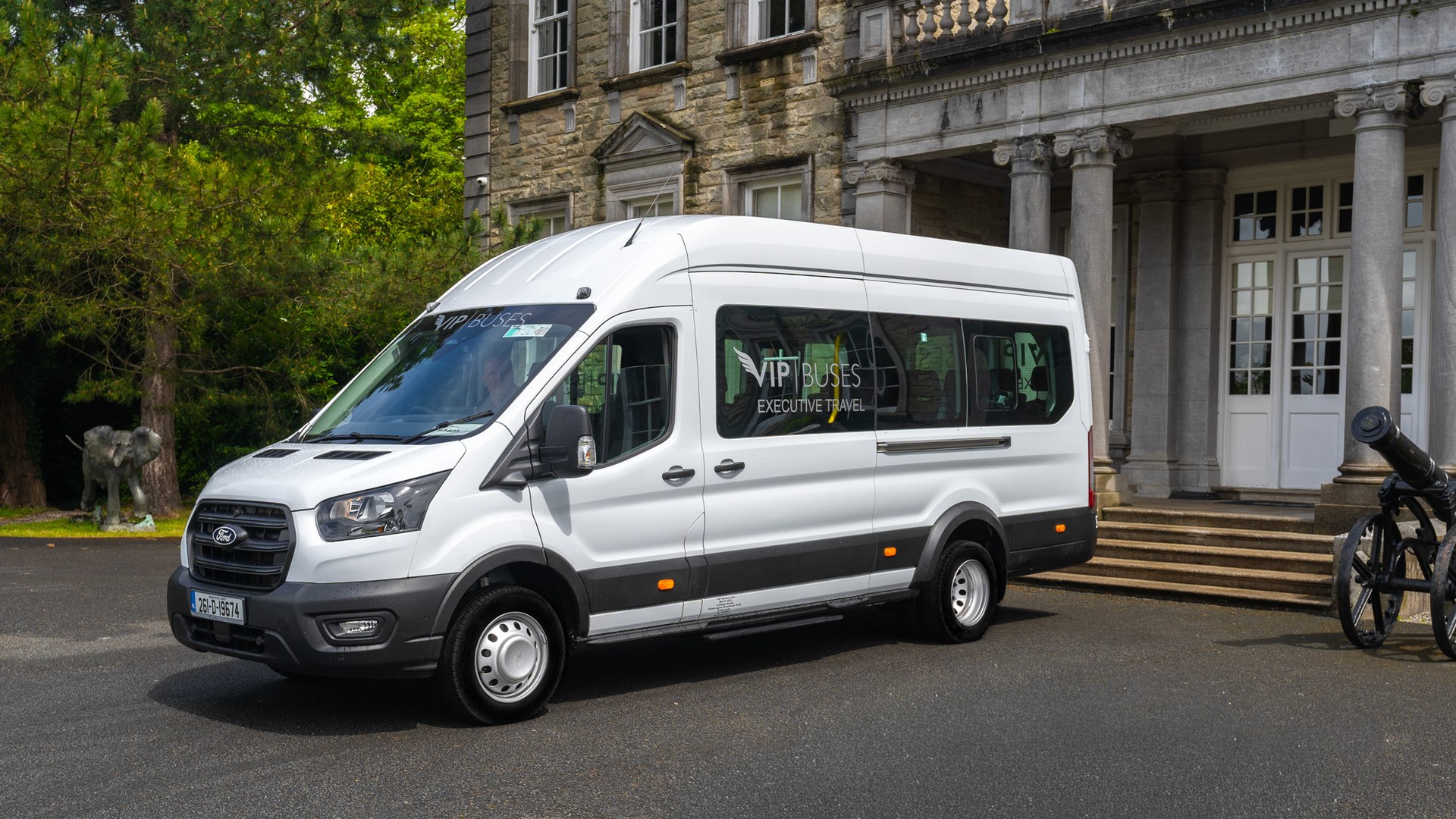 VIP Buses Ford Transit 17 Seater Minibus front three quarter with the driver at the wheel