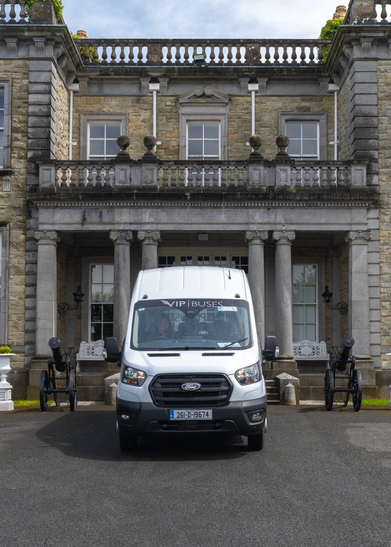 VIP Buses Ford Transit 17 Seater Minibus head on in front of the country house facade