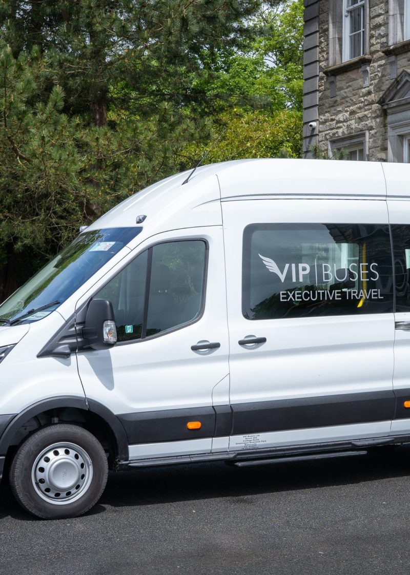 VIP Buses Ford Transit 17 Seater Minibus side profile in white livery at a country house