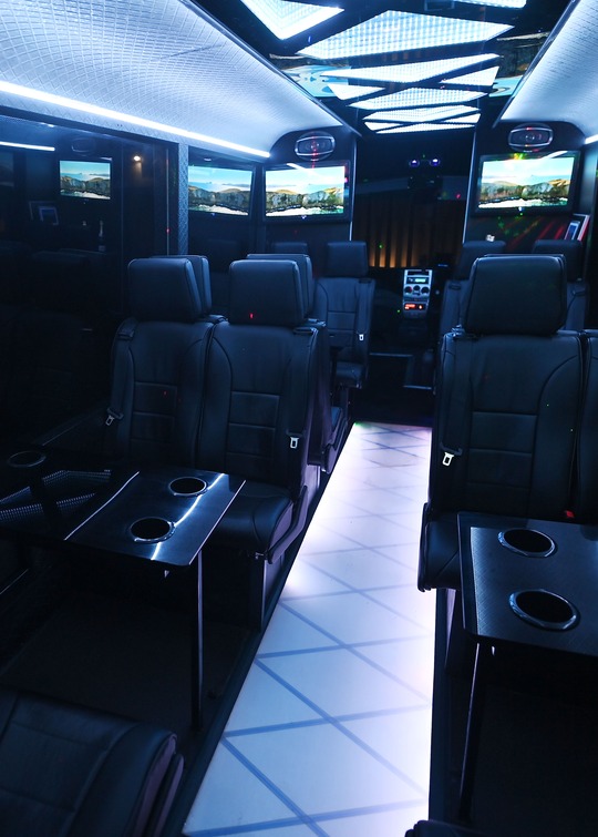 VIP Buses Iveco 16 Seater Party Bus cabin from a rear side angle aisle running to the right