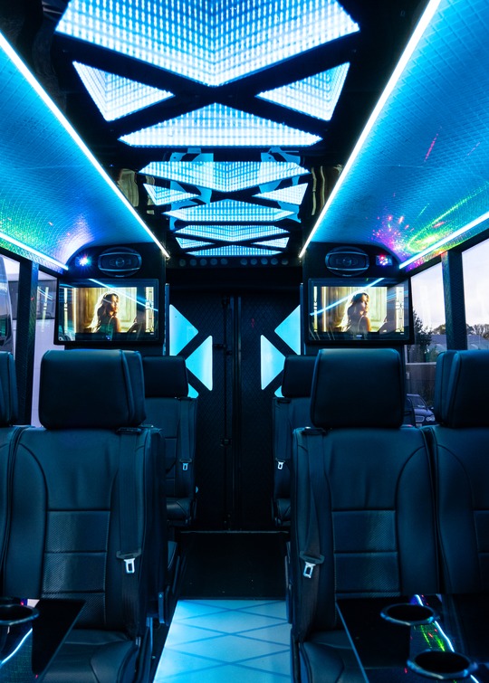 VIP Buses Iveco 16 Seater Party Bus cabin under cyan LEDs with the mirrored ceiling