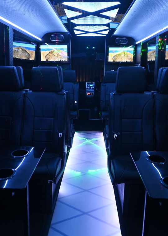 VIP Buses Iveco 16 Seater Party Bus cabin with lasers over the lit floor