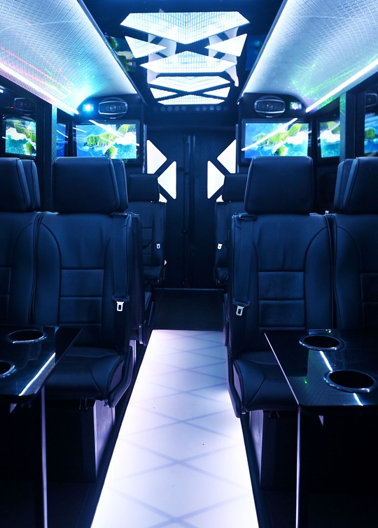 VIP Buses Iveco 16 Seater Party Bus cabin with screens both sides and the aisle lit white