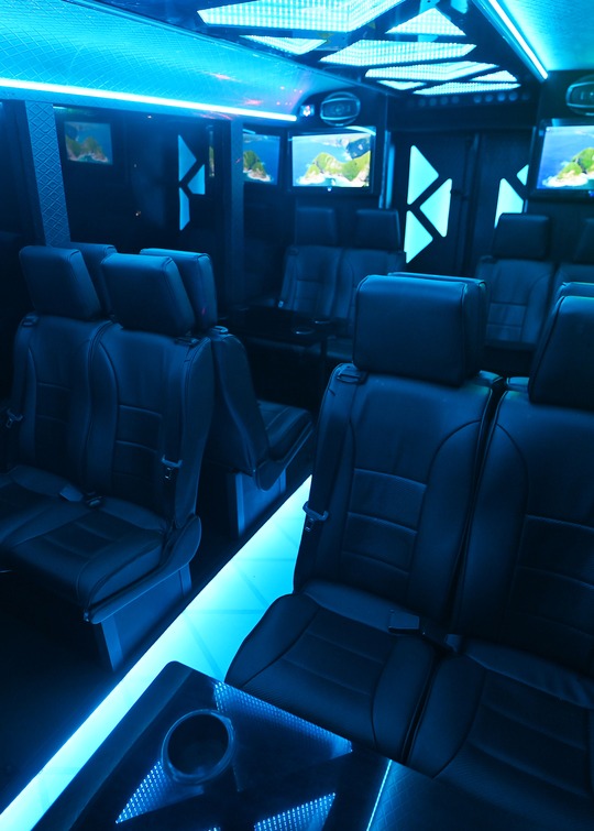 VIP Buses Iveco 16 Seater Party Bus seats and screens from a rear side angle