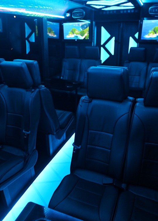 VIP Buses Iveco 16 Seater Party Bus seats from the side with the lit aisle to the right