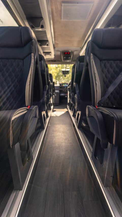 VIP Buses Mercedes Sprinter 16 Seater Minibus aisle forward with sun flaring on the screen