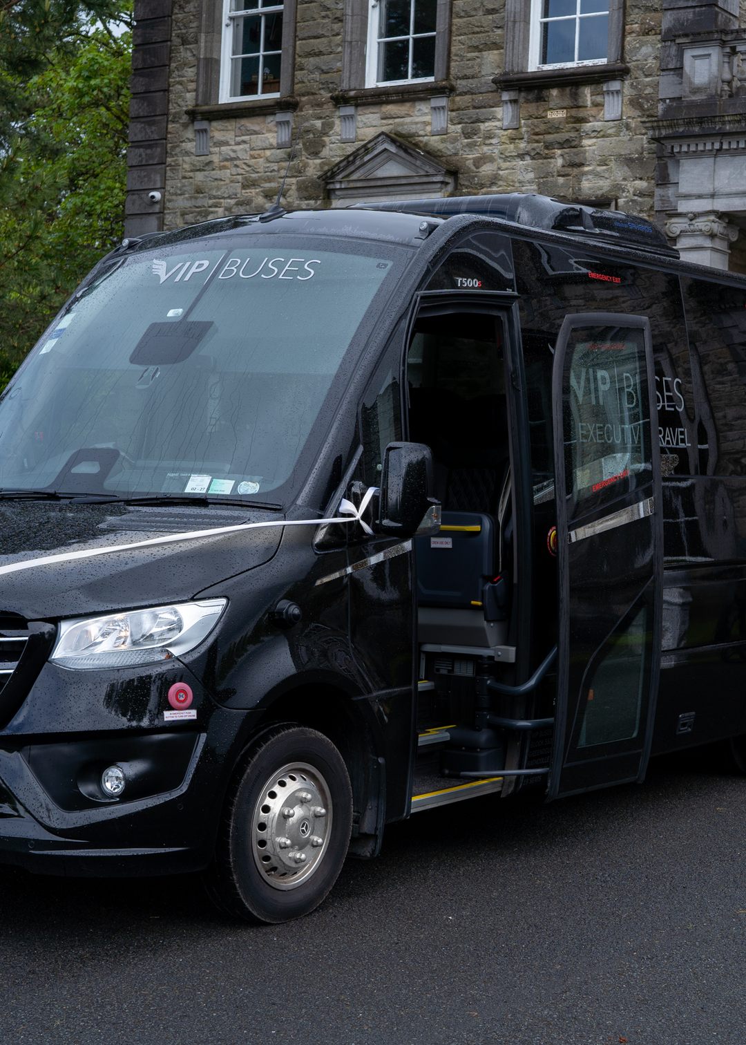 VIP Buses Mercedes Sprinter 16 Seater Minibus dressed with wedding ribbons and the door open