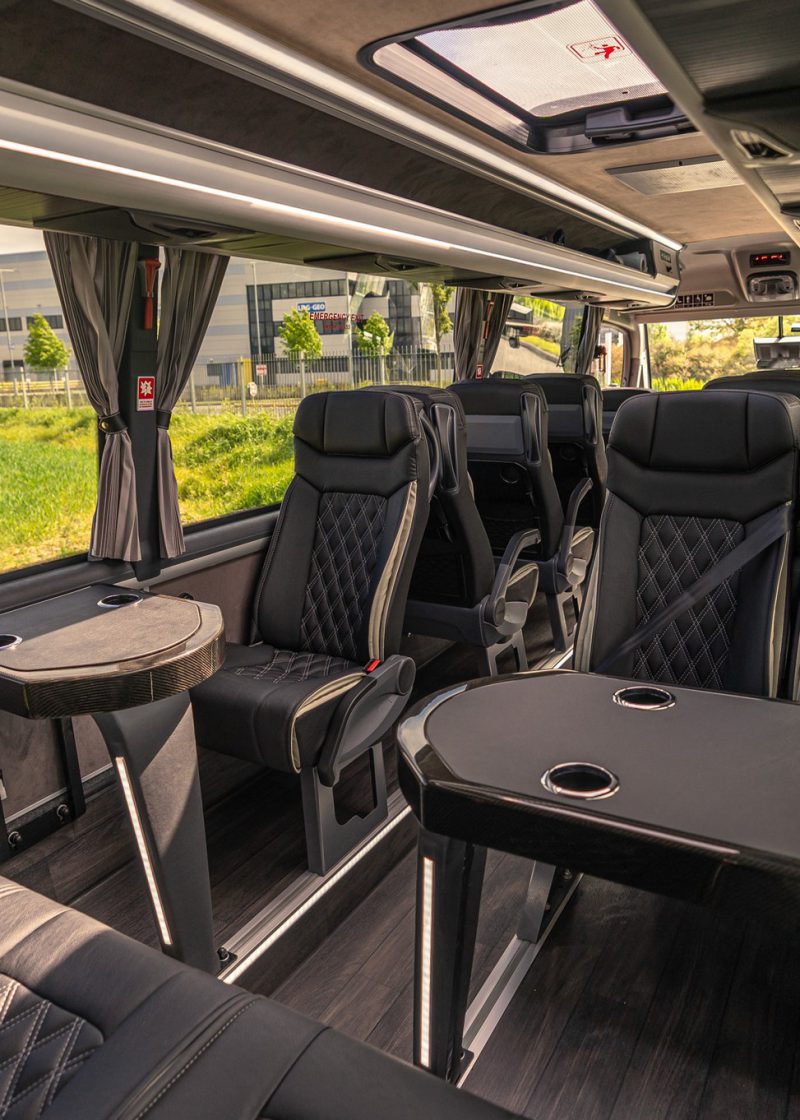 VIP Buses Mercedes Sprinter 16 Seater Minibus tables and seats in low evening sun