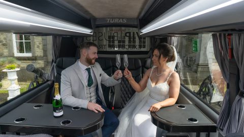 VIP Buses Mercedes Sprinter 16 Seater Minibus interior with the couple raising their glasses