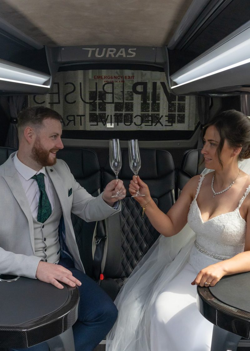 VIP Buses Mercedes Sprinter 16 Seater Minibus interior with the couple raising their glasses