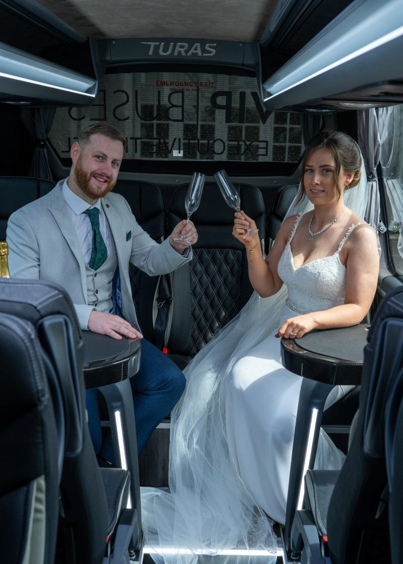 VIP Buses Mercedes Sprinter 16 Seater Minibus interior with the couple toasting champagne