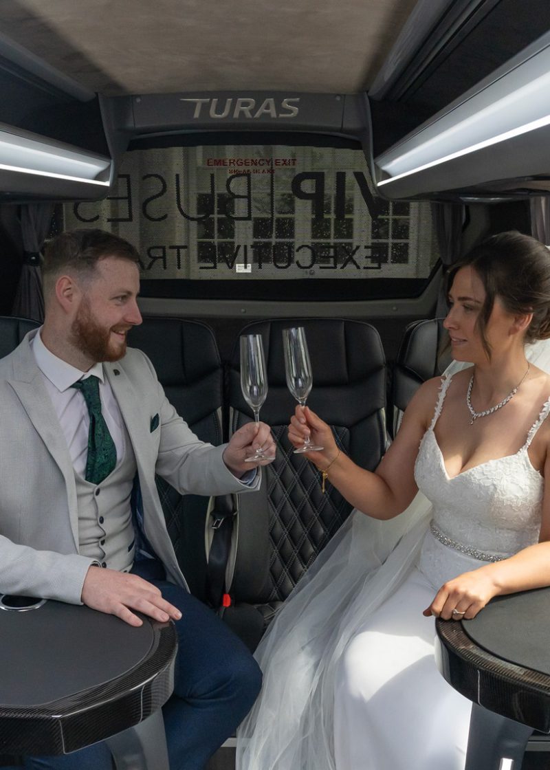 VIP Buses Mercedes Sprinter 16 Seater Minibus interior with the couple toasting champagne