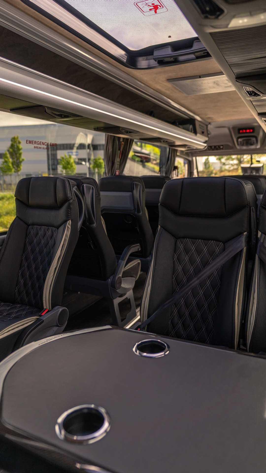 VIP Buses Mercedes Sprinter 16 Seater Minibus interior with the roof hatch open above