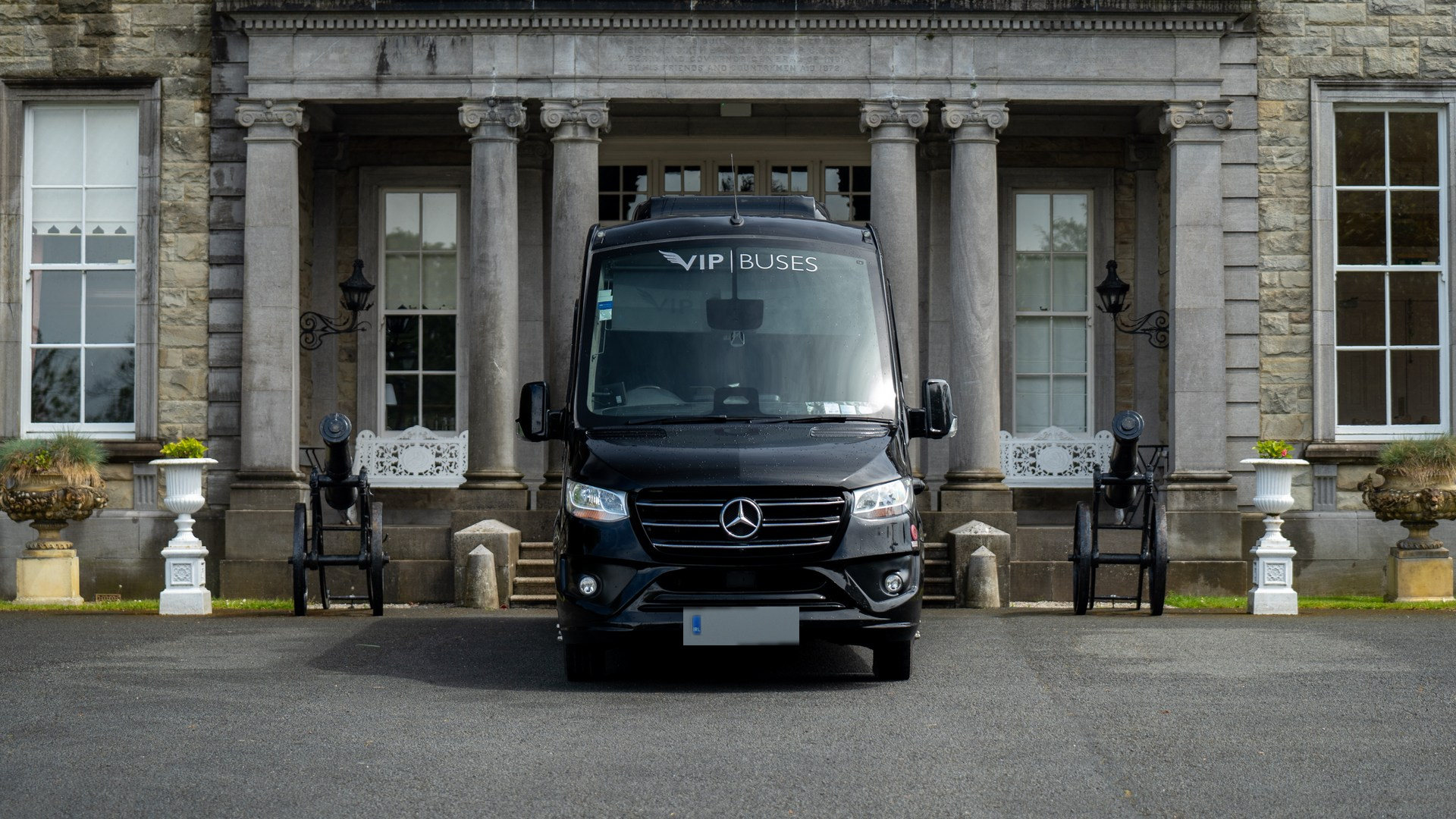 VIP Buses Mercedes Sprinter 16 Seater Minibus parked head on between two cannons