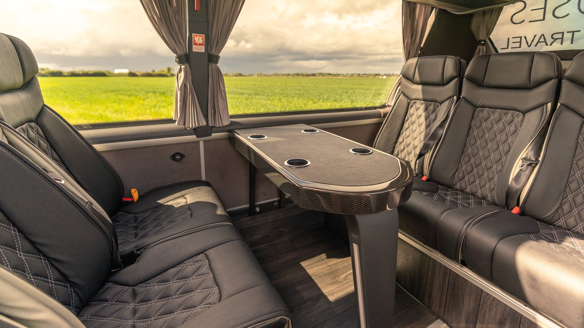 VIP Buses Mercedes Sprinter 16 Seater Minibus rear lounge facing benches at golden hour