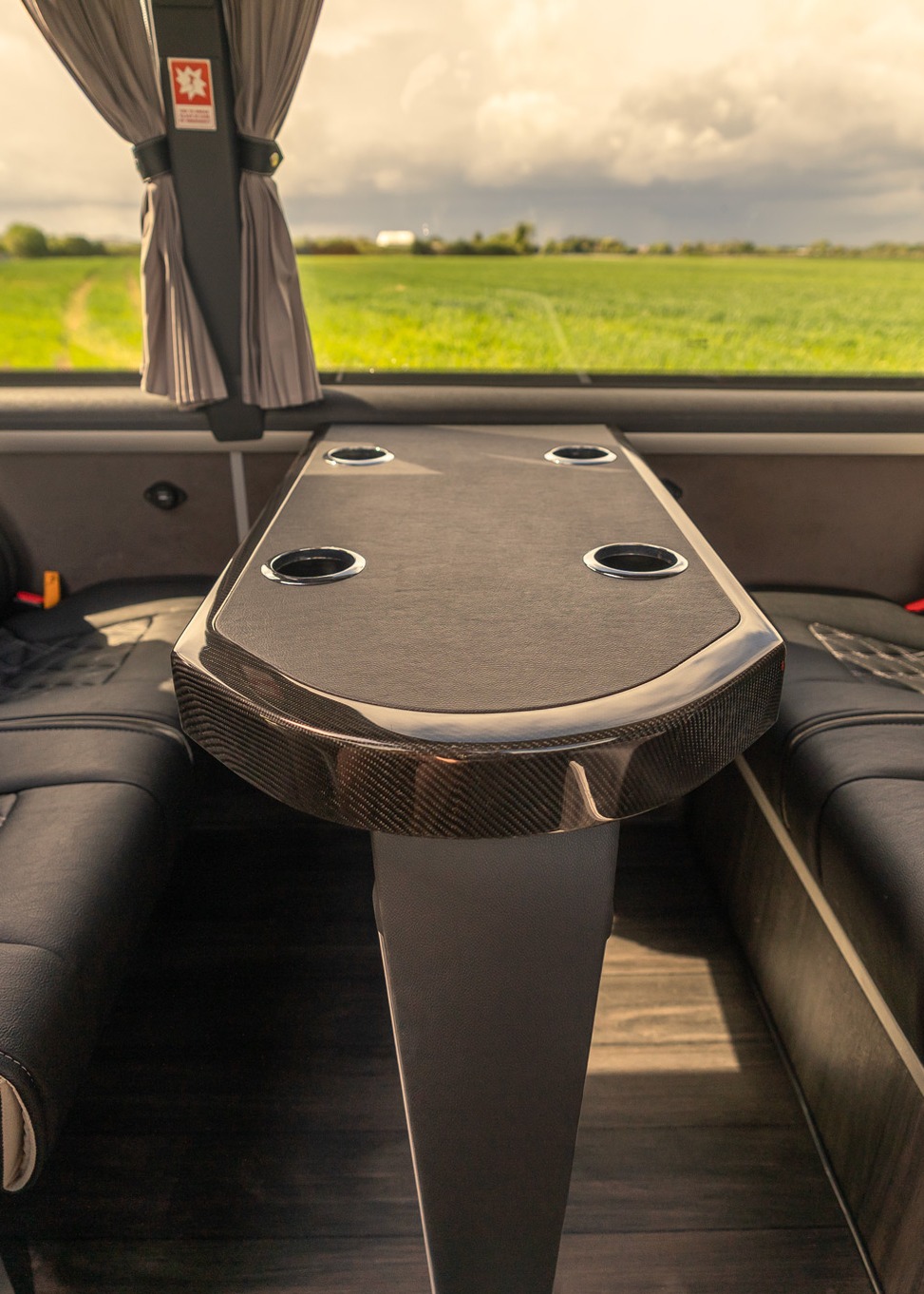 VIP Buses Mercedes Sprinter 16 Seater Minibus rear lounge with facing benches and a table