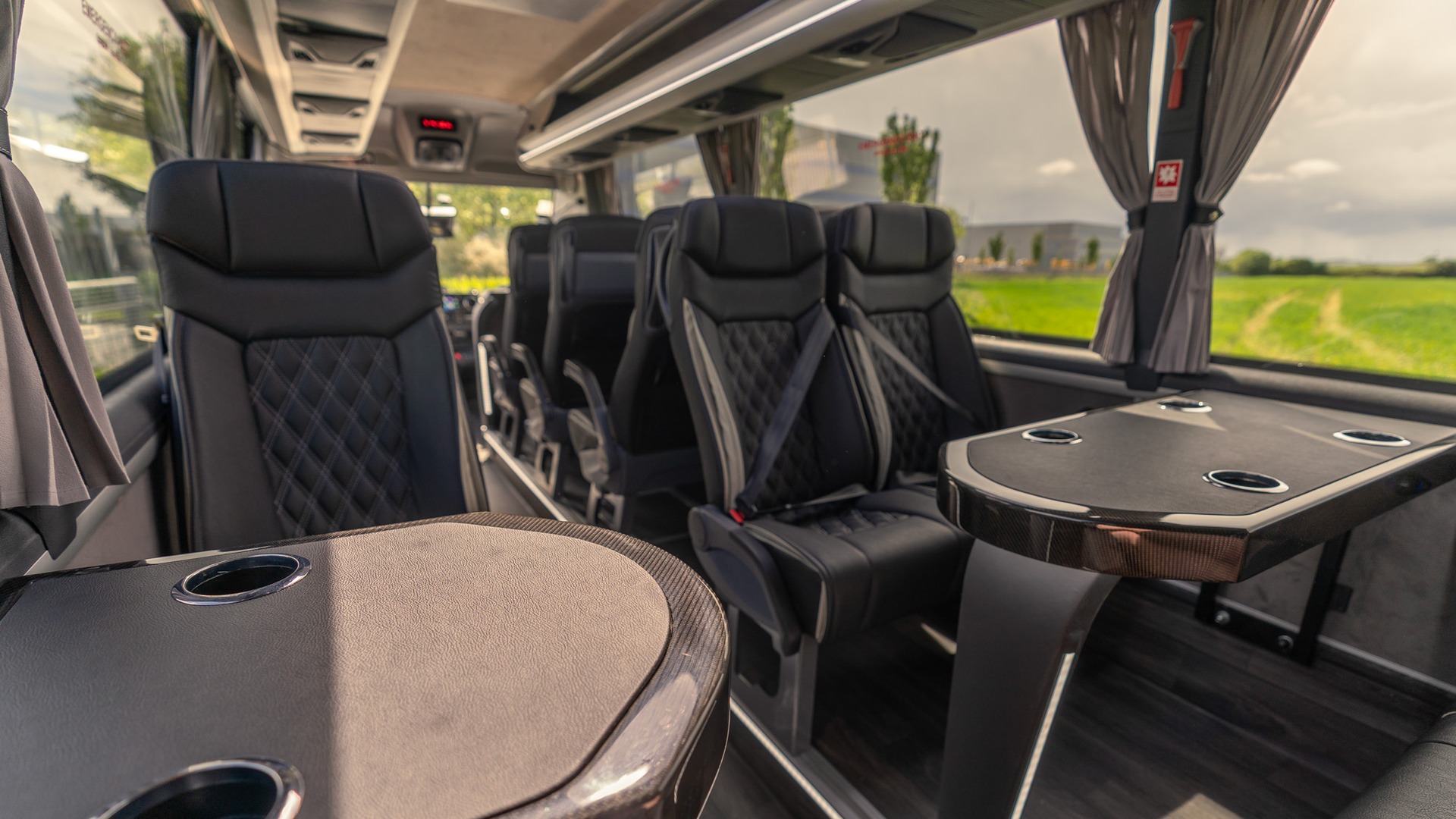 VIP Buses Mercedes Sprinter 16 Seater Minibus tables and seats receding at golden hour