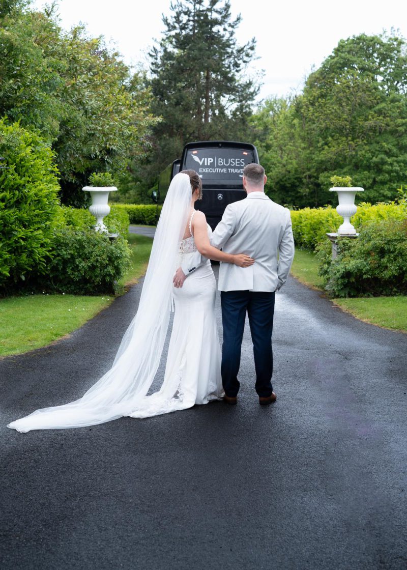 VIP Buses Mercedes Sprinter 16 Seater Minibus with the bride and groom arm in arm outside