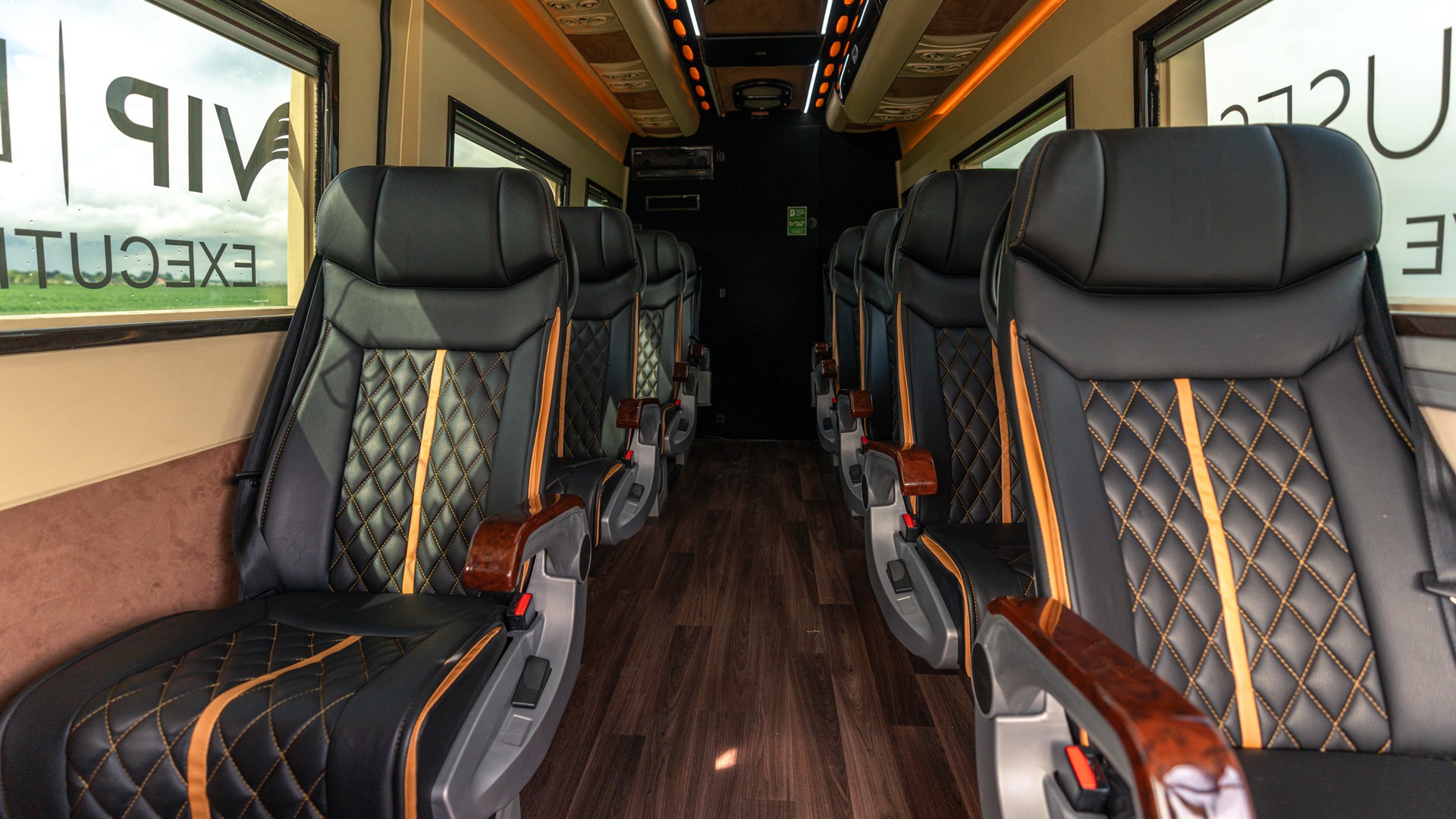 VIP Buses Mercedes Sprinter 9 Seater Minibus aisle to the rear door under orange lighting